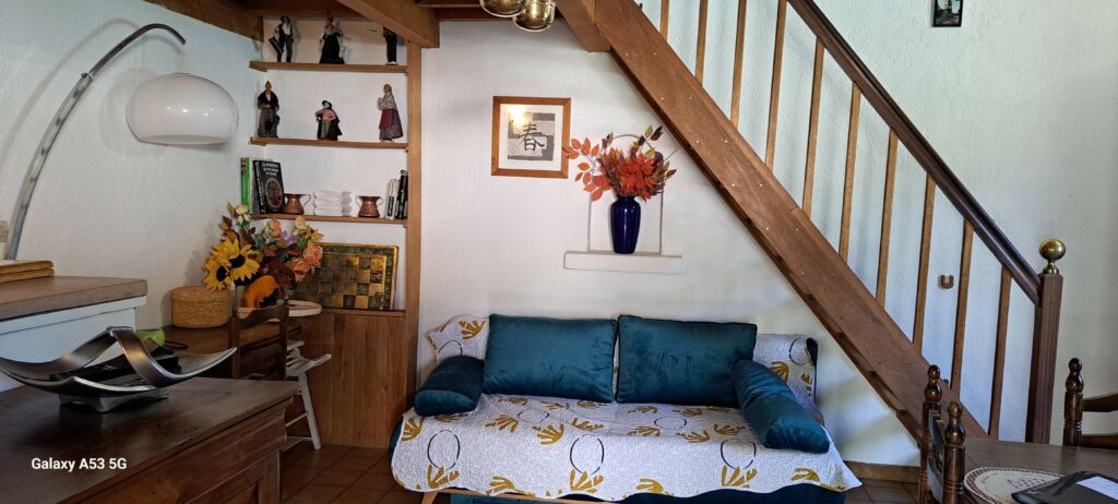 Canapé et son coin bureau dans la pièce à vivre de l'Oustau dei Aucèus.